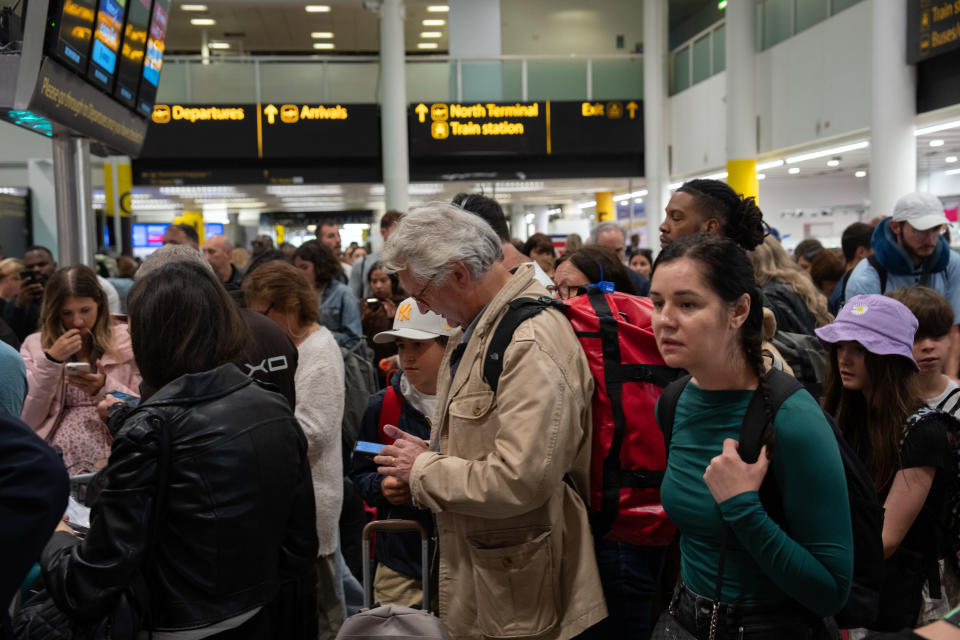 CRAWLEY, ENGLAND - AUGUST 28: People wait near check-in desks at Gatwick Airport on August 28, 2023 in Crawley, United Kingdom. The United Kingdom's air traffic control systems have grounded thousands of flights on one of the busiest travel days of the year. All flights to and from the UK are reported to be affected and delays could last for days. (Photo by Carl Court/Getty Images)