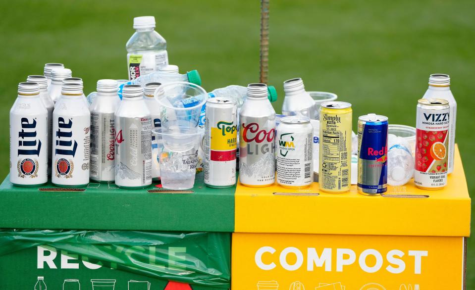 Beer cans and drinks sit ontop of the Waste Management trash and recycle bins during the second round at the WM Phoenix Open at TPC Scottsdale on Feb. 9, 2024.