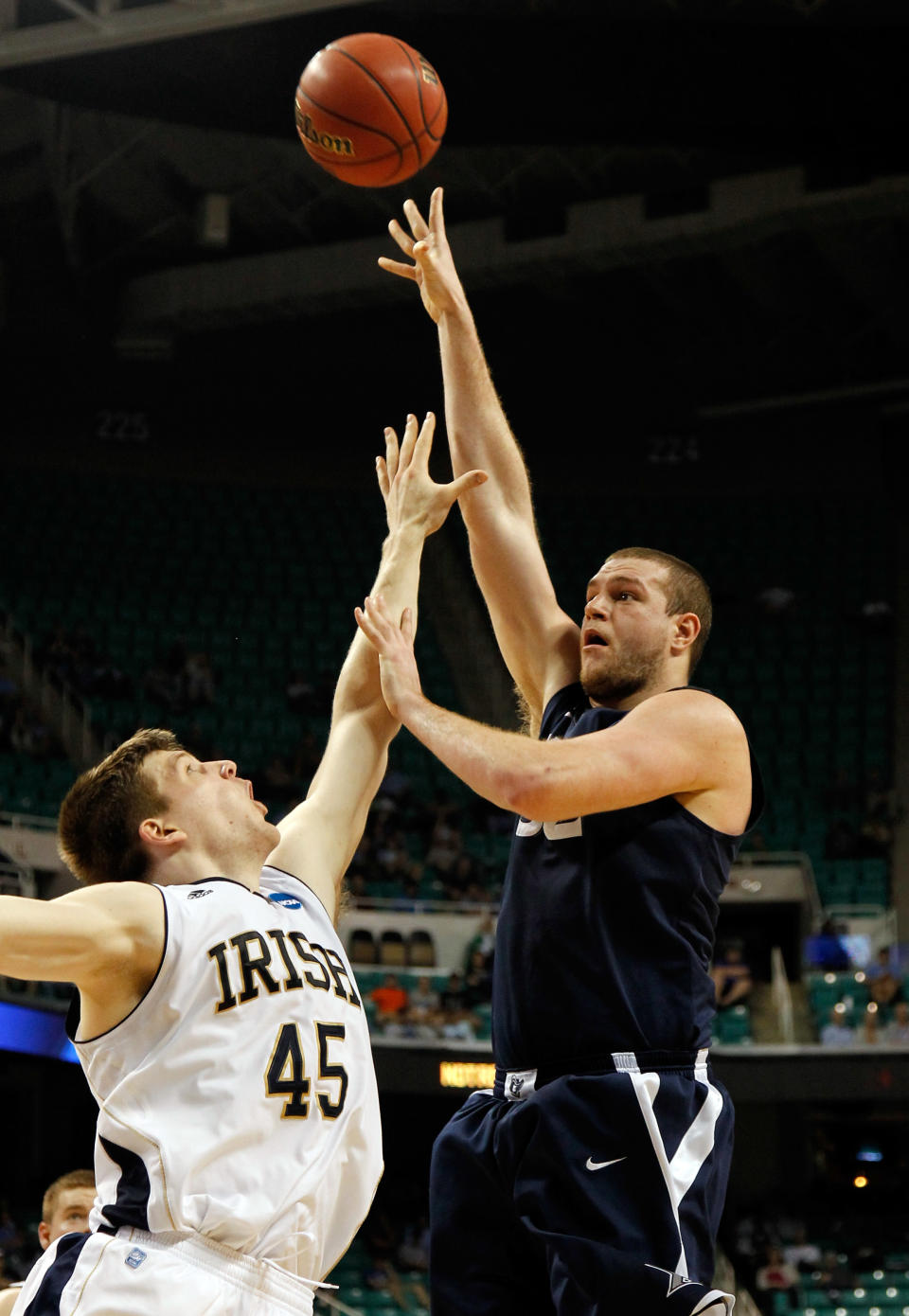 GREENSBORO, NC - MARCH 16: Kenny Frease #32 of the Xavier Musketeers shoots over Jack Cooley #45 of the Notre Dame Fighting Irish in the first half during the second round of the 2012 NCAA Men's Basketball Tournament at Greensboro Coliseum on March 16, 2012 in Greensboro, North Carolina. (Photo by Mike Ehrmann/Getty Images)