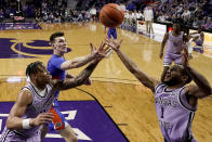 Kansas State forward Keyontae Johnson, left, and guard Markquis Nowell (1) compete for a rebound with Florida forward Colin Castleton, center, during the first half of an NCAA college basketball game Saturday, Jan. 28, 2023, in Manhattan, Kan. (AP Photo/Charlie Riedel)