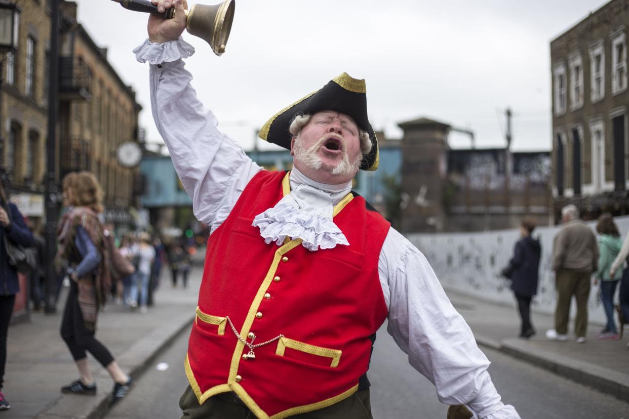 London, United Kingdom - May 29, 2016: Town Crier dressed in traditional costume rings his bell and announces the news.