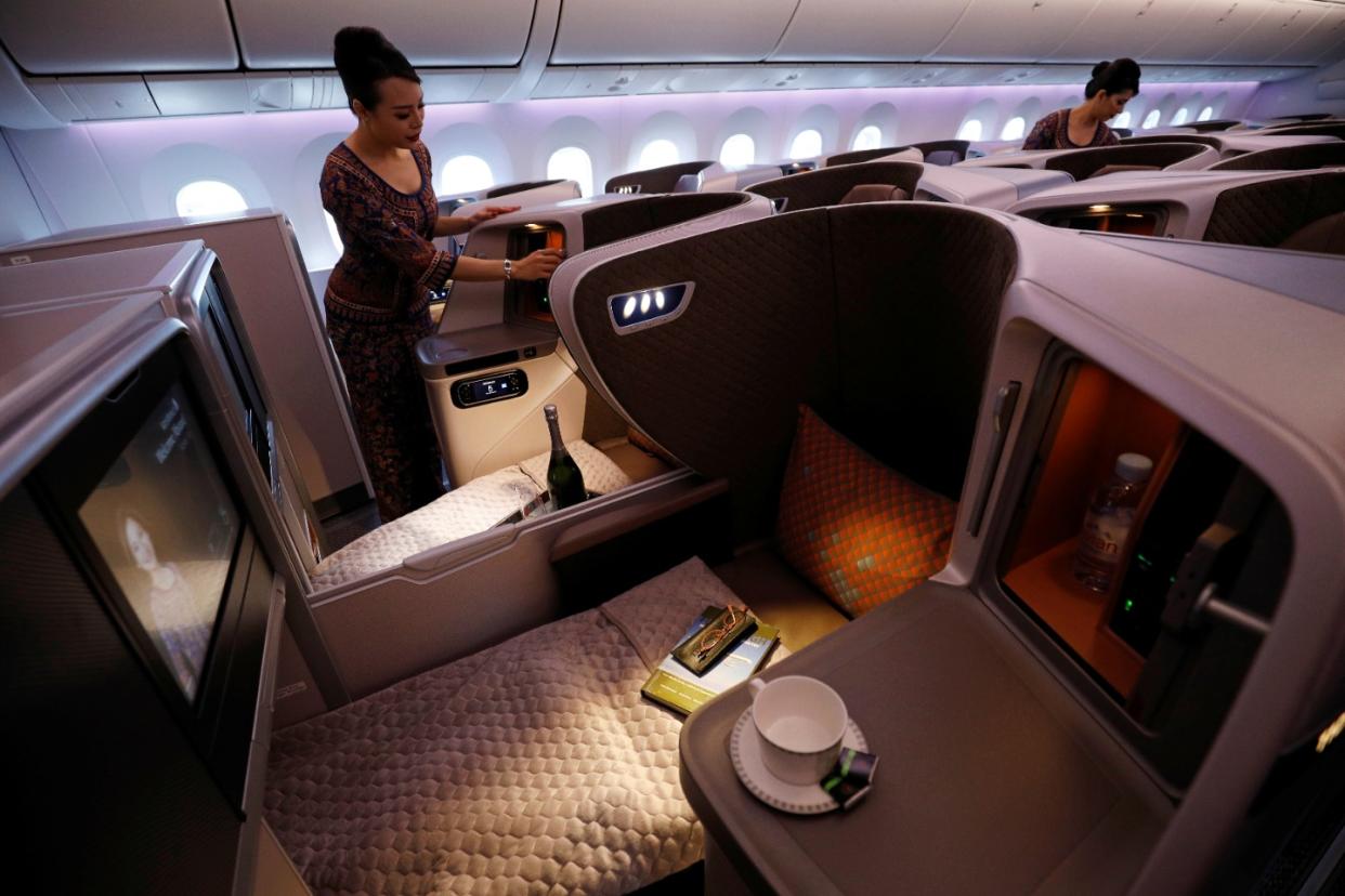 Singapore Airlines flight attendants showcase the Business Class cabin of their first Boeing 787-10 Dreamliner at Singapore's Changi Airport March 28, 2018. REUTERS/Edgar Su