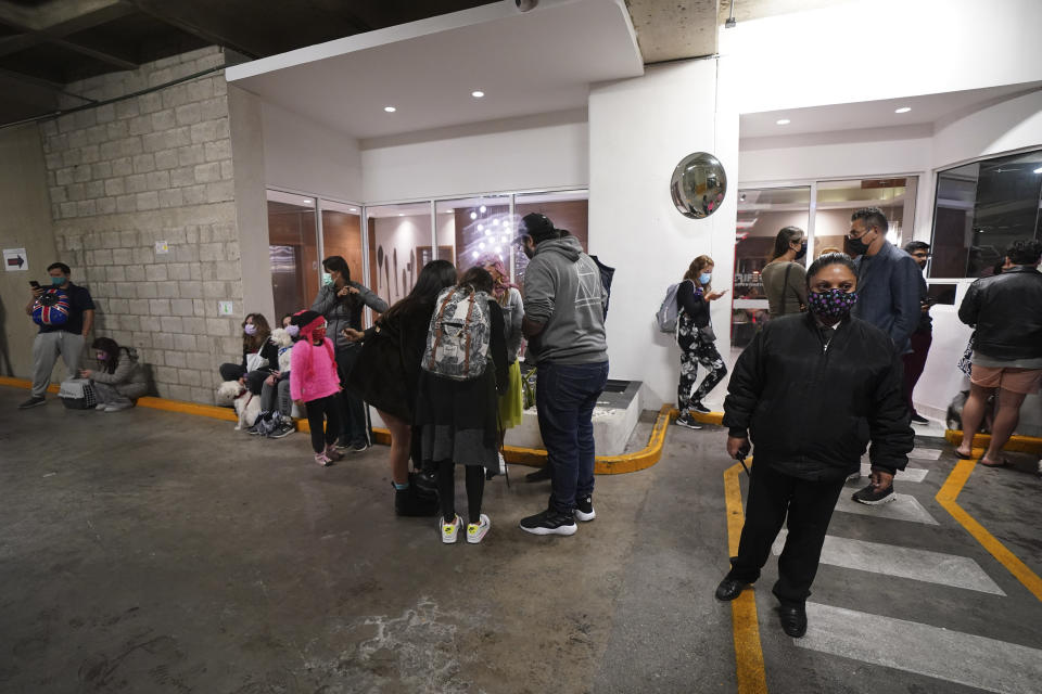 People gather outside a building after a strong earthquake, in Mexico City, Tuesday, Sept. 7, 2021. The quake struck southern Mexico near the resort of Acapulco, causing buildings to rock and sway in Mexico City nearly 200 miles away. (AP Photo/Marco Ugarte)