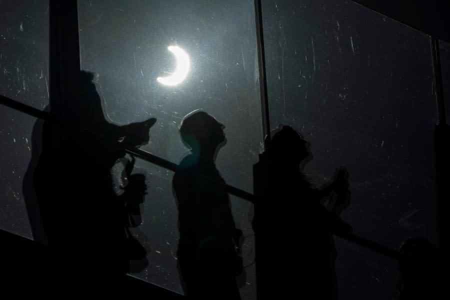 FILE – People watch a rare “ring of fire” solar eclipse along the Las Vegas Strip, Saturday, Oct. 14, 2023, in Las Vegas. (AP Photo/John Locher, File)