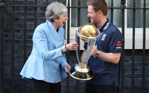 Prime Minister Theresa May with England cricket captain Eoin Morgan and the trophy outside Downing Street - Credit: Yui Mok/PA