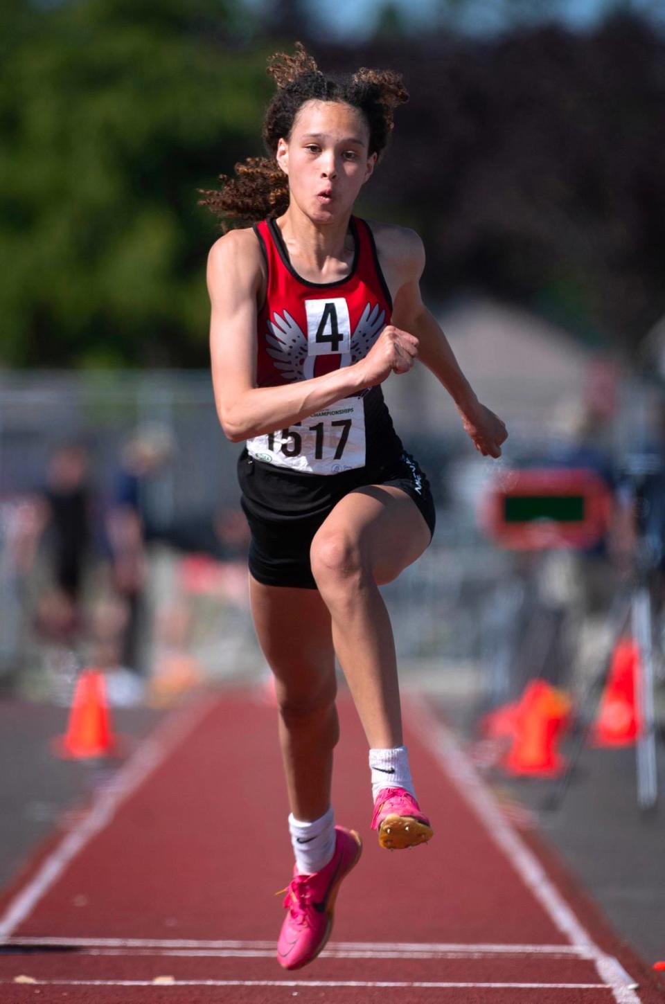 Orting’s Myquela Pride leaps to a state title in the 2A girls triple jump during the second day of the WIAA state track and field championships at Mount Tahoma High School in Tacoma, Washington, on Friday, May 26, 2023. Later in the day, Pride added a surprise state championship in the 2A girls 100-meter hurdles.