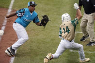 Taiwan's Chiu Tse-Wei (14) tries to avoid the tag by Curacao first baseman Yaedon Lourens Martie after he bunted the ball down the first base line during the fourth inning of a baseball game at the Little League World Series in South Williamsport, Pa., Wednesday, Aug. 23, 2023. Tse-Wei was called out for being out the the baseline. (AP Photo/Tom E. Puskar)
