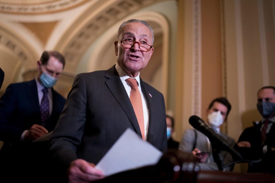 Senate Majority Leader Chuck Schumer, D-N.Y., joined at left by Sen. Ron Wyden, D-Ore., chair of the Senate Finance Committee, speaks to reporters Tuesday after a weekly policy meeting, at the Capitol in Washington, D.C.