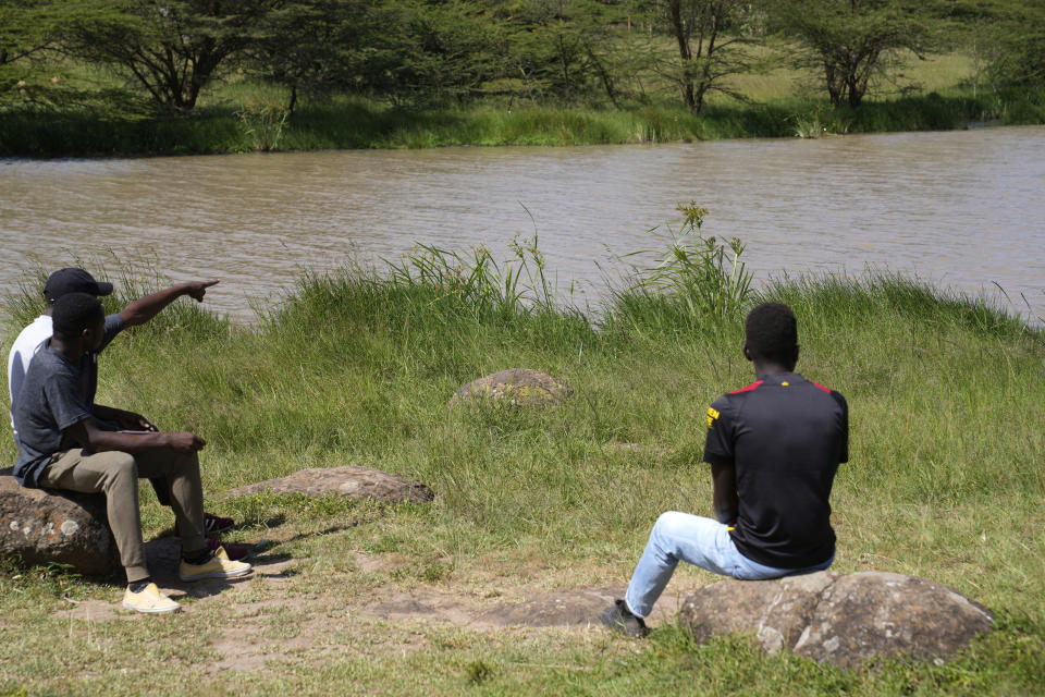 A local person points where Anthony Shungea Pasha who was thoroughly dismembered and killed by hyenas while he was collecting firewood at a forest neighbouring his homestead, in Kajiado, Kenya Tuesday, Feb. 6, 2024. The wild animals from the Nairobi National Park have been distressing the community. "Everything has been killed in this homestead. Cows were killed, goats and now its people. We haven't found any part of the deceased. We have not been given any help," Gladys Maingu, relative to Pasha, echoed. (AP Photo/Brian Inganga)