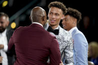 Dyson Daniels is congratulated by family and friends after being selected eighth overall by the New Orleans Pelicans in the NBA basketball draft, Thursday, June 23, 2022, in New York. (AP Photo/John Minchillo)