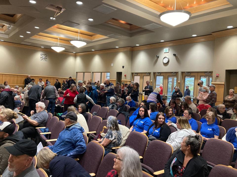 People inside the Shasta County Board of Supervisors wait for supervisors to return from closed session on Tuesday, March 27, 2023.