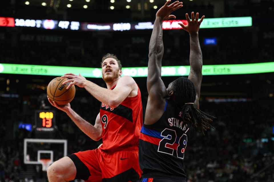 Toronto Raptors center Jakob Poeltl (19) attacks the net while guarded by Detroit Pistons center Isaiah Stewart (28) during the second half of an NBA basketball game, in Toronto, Sunday, Nov. 19, 2023. (Christopher Katsarov/The Canadian Press via AP)