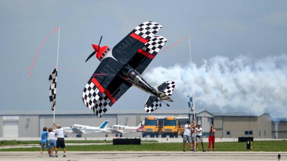 Skip Stewart turns his plane Prometheus like to become a “knife’s edge” in order to cut a ribbon just 10 feet of the ground on the second and final day of the 2021 Kansas City Airshow at the New Century AirCenter in New Century, Kansas, Sunday, July 4, 2021.