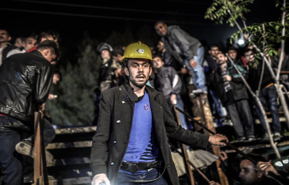 Miners wait at the gate of a mine after an explosion in Manisa on May 13, 2014. (BULENT KILIC/AFP/Getty Images)