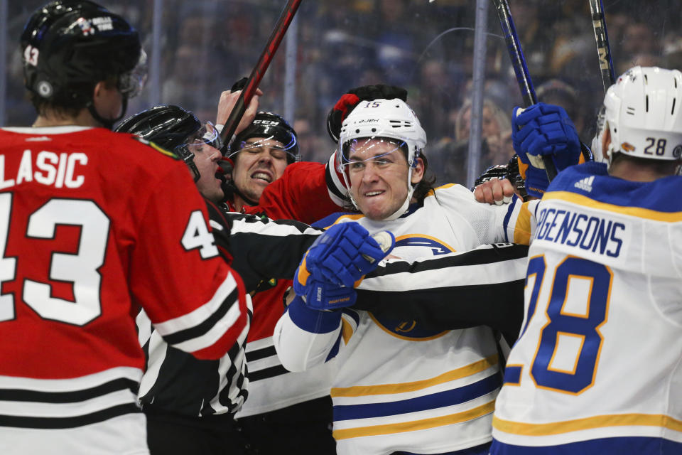 Buffalo Sabres center John Hayden, center, is restrained by officials during the second period of the team's NHL hockey game against the Chicago Blackhawks on Friday, April 29, 2022, in Buffalo, N.Y. (AP Photo/Joshua Bessex)