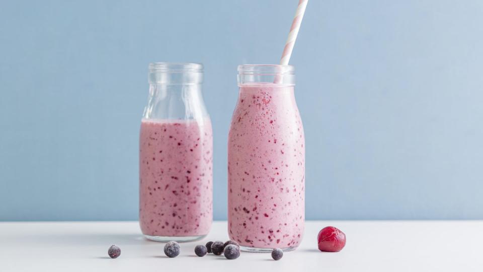 front view pink smoothie bottles with blueberries