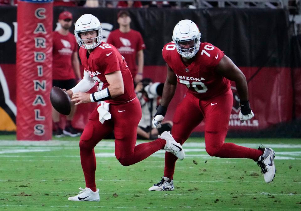 Arizona Cardinals quarterback Colt McCoy (12) and offensive tackle Paris Johnson Jr. (70) against the Kansas City Chiefs in the first half during a preseason game at State Farm Stadium in Glendale on Aug. 19, 2023.