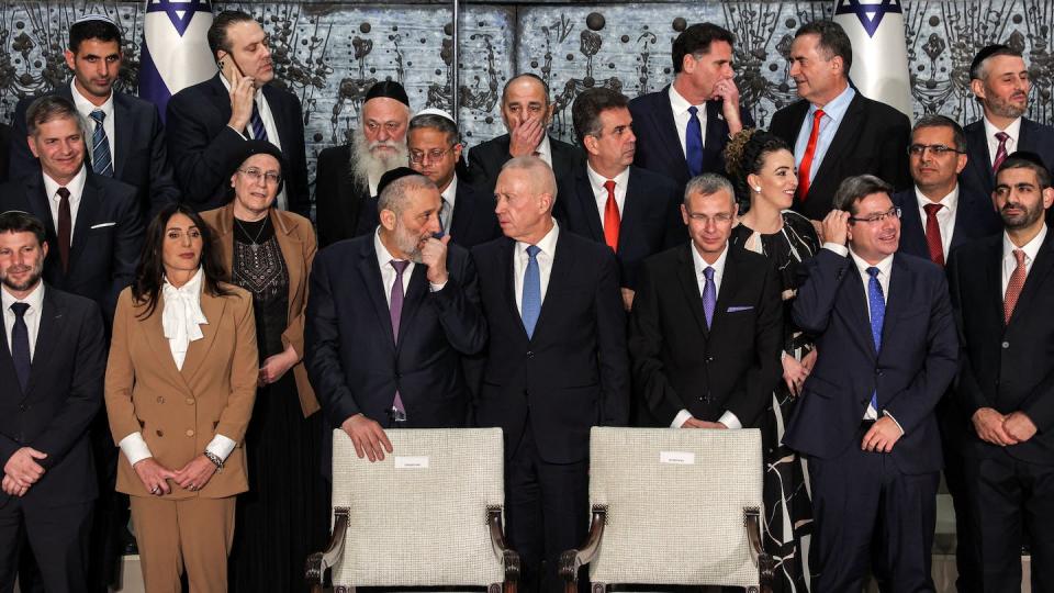 Ministers of Israel’s 37th government wait to have their group picture taken with the president and prime minister at the president’s residence in Jerusalem on Dec. 29, 2022. <a href="https://www.gettyimages.com/detail/news-photo/ministers-of-israels-37th-government-wait-to-have-their-news-photo/1245871762?phrase=netanyahu&adppopup=true" rel="nofollow noopener" target="_blank" data-ylk="slk:Photo by Gil Cohen-Magen/AFP via Getty Images;elm:context_link;itc:0;sec:content-canvas" class="link ">Photo by Gil Cohen-Magen/AFP via Getty Images</a>