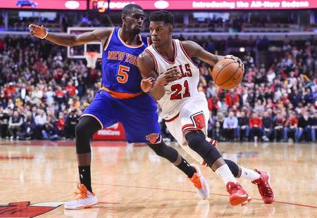 Chicago Bulls guard Jimmy Butler (21) dribbles the ball against New York Knicks guard Tim Hardaway Jr. (5) during the second half at United Center. The Chicago Bulls defeat the New York Knicks 103-97. Mandatory Credit: Mike DiNovo-USA TODAY Sports