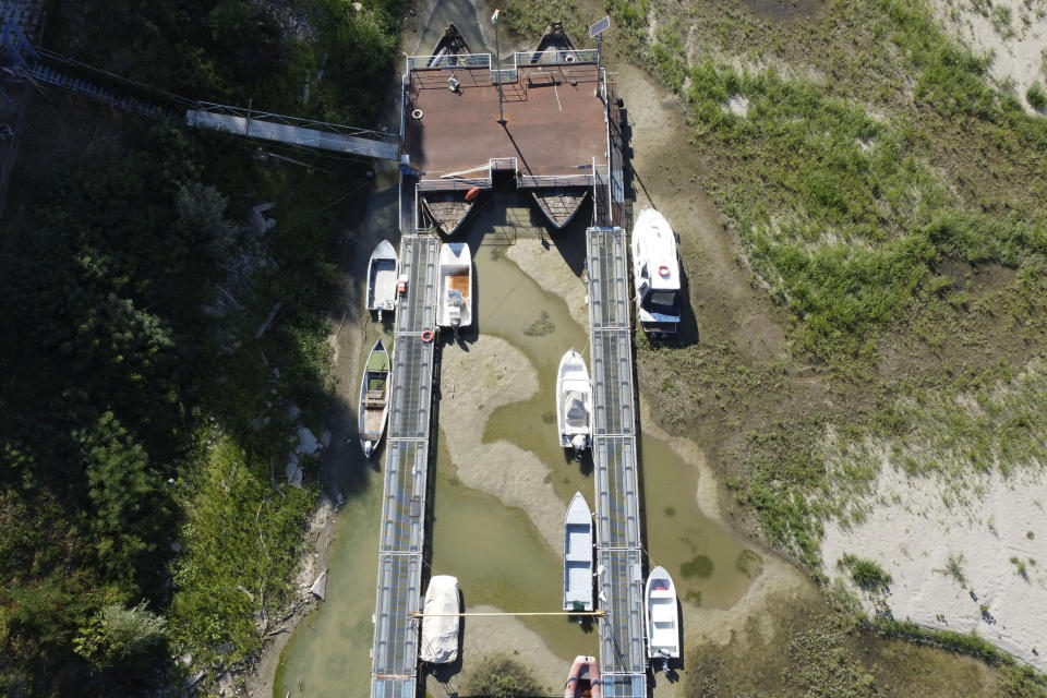 FILE - Boats lie on the dried riverbed at a tourist dock along the Po river in Sermide, Italy, Thursday, Aug. 11, 2022. The river Po runs 652 kilometers (405 miles) from the northwestern city of Turin to Venice. (AP Photo/Luigi Navarra, File)