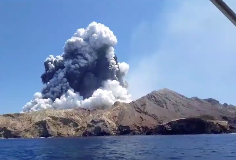 Smoke from the volcanic eruption of Whakaari, also known as White Island, is pictured from a boat