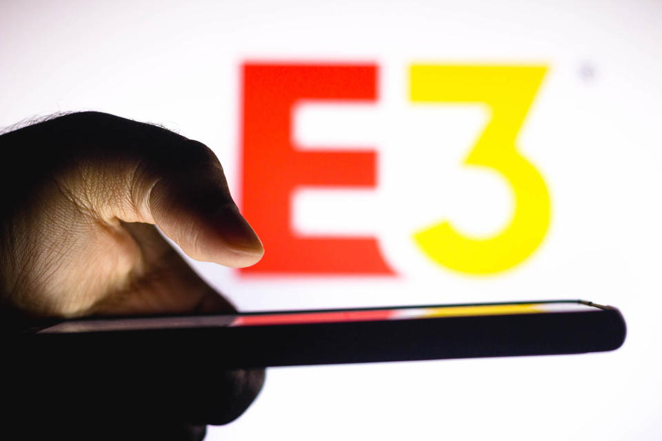 BRAZIL - 2021/01/20: In this photo illustration, a hand of a person holds a smartphone with an Electronic Entertainment Expo (E3) logo displayed in the background. (Photo Illustration by Rafael Henrique/SOPA Images/LightRocket via Getty Images)