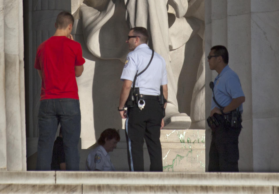 Splattered green paint is seen on the right shoe area of the Abraham Lincoln statue at the Lincoln Memorial in Washington, Friday, July 26, 2013. Police say the apparent vandalism was discovered early Friday morning. No words, letters or symbols were visible in the paint. (AP Photo/J. Scott Applewhite)