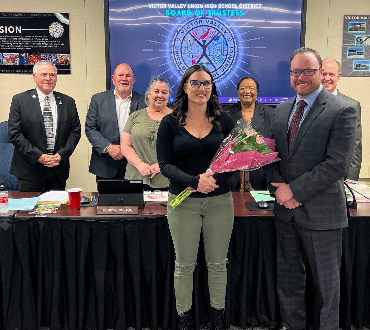 Silverado High School Teacher Janette Gomez, center, School District Superintendent Carl Coles (foreground right) pose with the VVUHSD Board of Trustees, back row from left to right: Rosie Hinojos, Jose Berrios, Penny Edmiston, Barbara Dew and Kent Crosby. Gomez was recently recognized by the California League of Educators as one of the top high school teachers in the region.