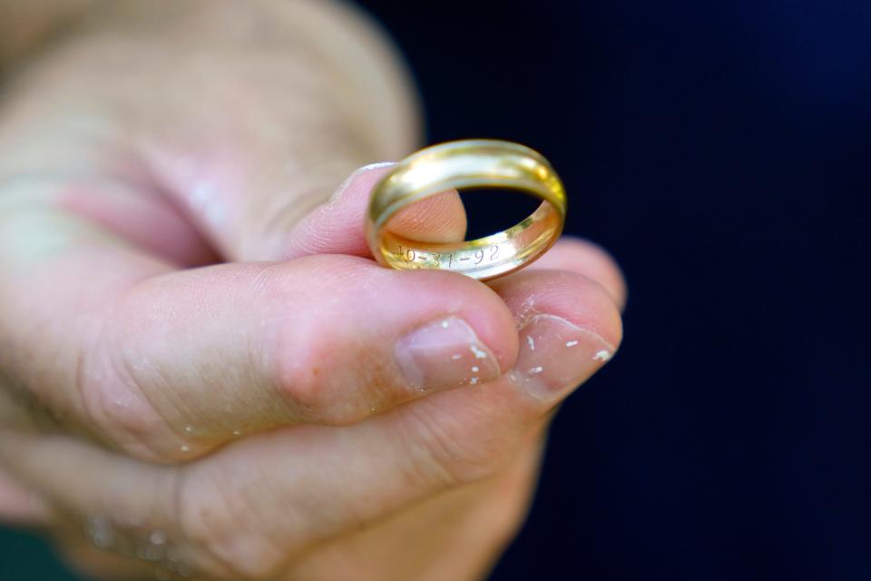 Shawn Emery holds his wedding ring which has been missing for the last 28 years until found by Michele Cohen in her garden in Glen Rock. The Emery's wedding anniversary is engraved on the inside of the ring.