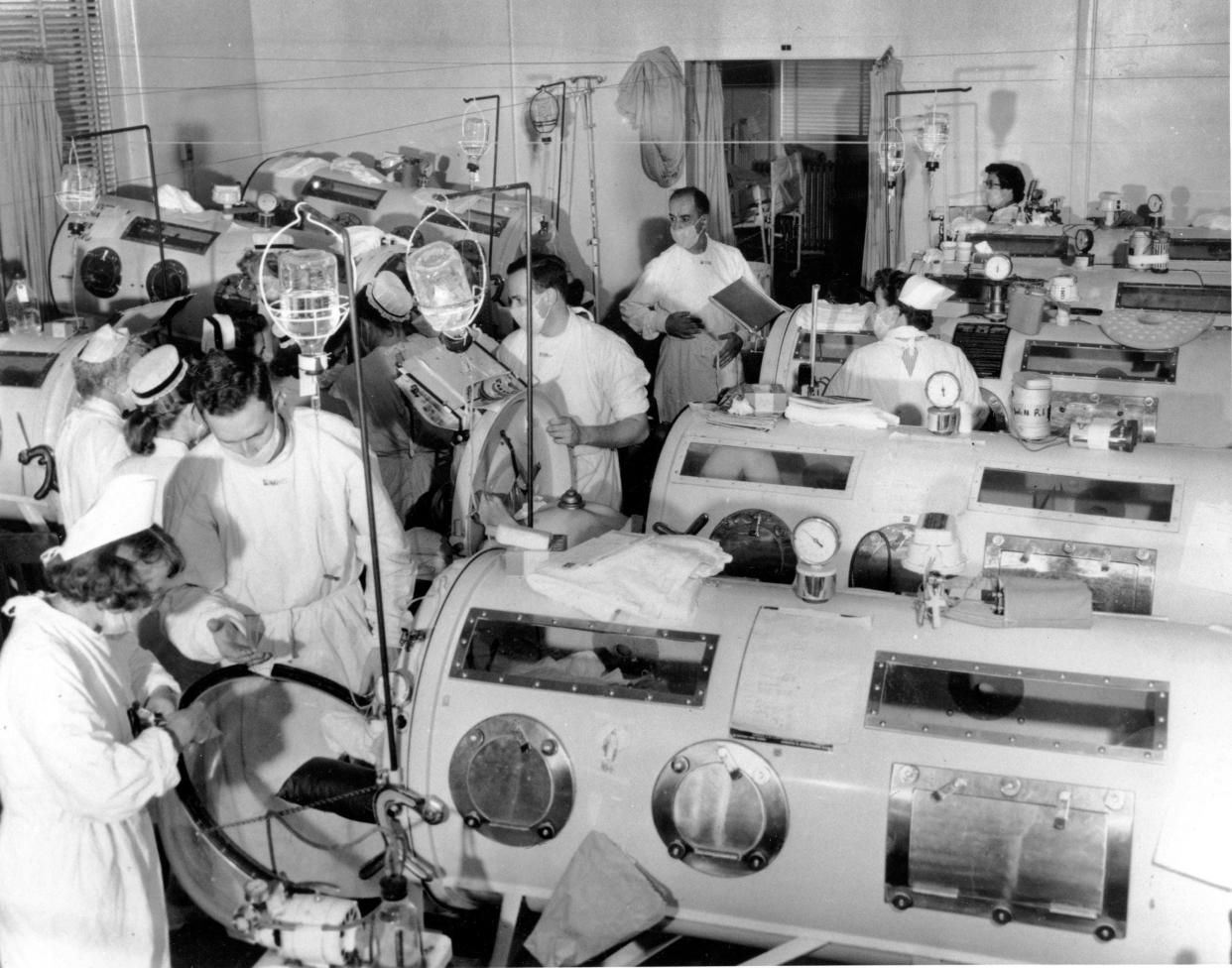 An image of the emergency polio ward at Haynes Memorial Hospital in Boston in 1955, showing critical victims lined up in iron lung respirators. The coffin-like devices helped those whose bodies were crippled by polio breathe artificially. Later in 1955, Jonas Salk discovered the vaccine for polio, which today has been eradicated from all but three countries.