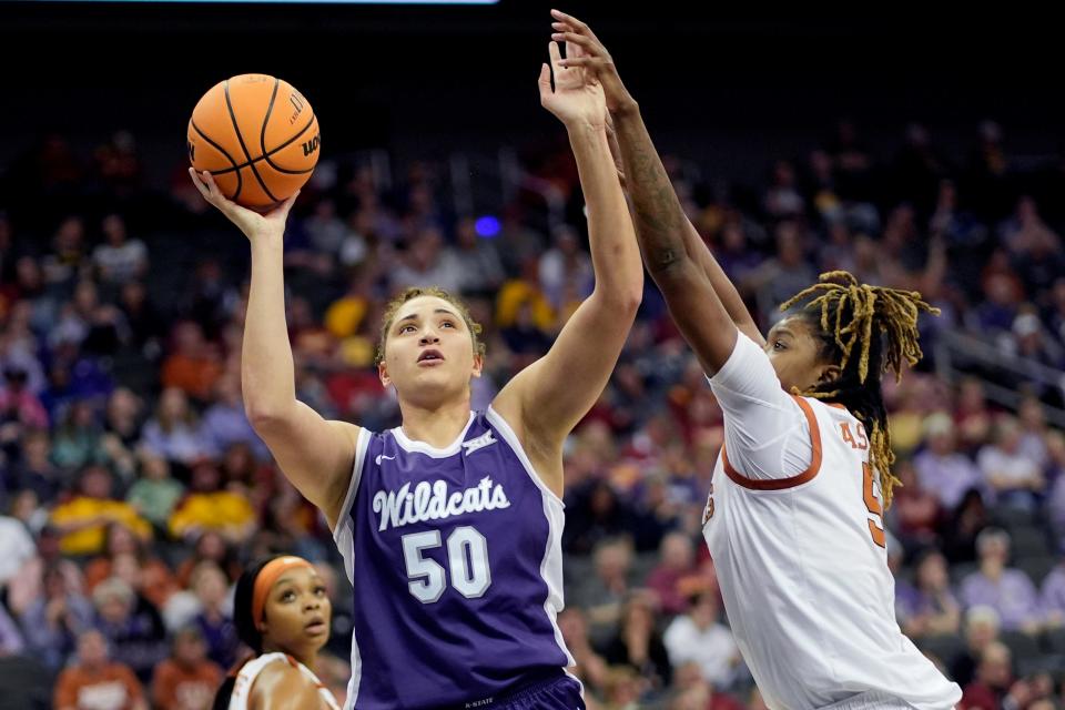 Kansas State center Ayoka Lee (50) shoots over Texas' DeYona Gaston, right, during the Big 12 Tournament on March 11 at T-Mobile Center in Kansas City, Mo.