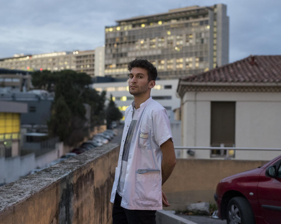 This photo taken on Dec.16, 2019 shows Nathan Demerle, a psychiatry intern on strike posing for a portrait in front of Marseille's La Timone hospital, southern France. In a hospital in Marseille, student doctors are holding an exceptional, open-ended strike to demand a better future. France’s vaunted public hospital system is increasingly stretched to its limits after years of cost cuts, and the interns at La Timone - one of the country’s biggest hospitals - say their internships are failing to prepare them as medical professionals. Instead, the doctors-in-training are being used to fill the gaps. (AP Photo/Daniel Cole)