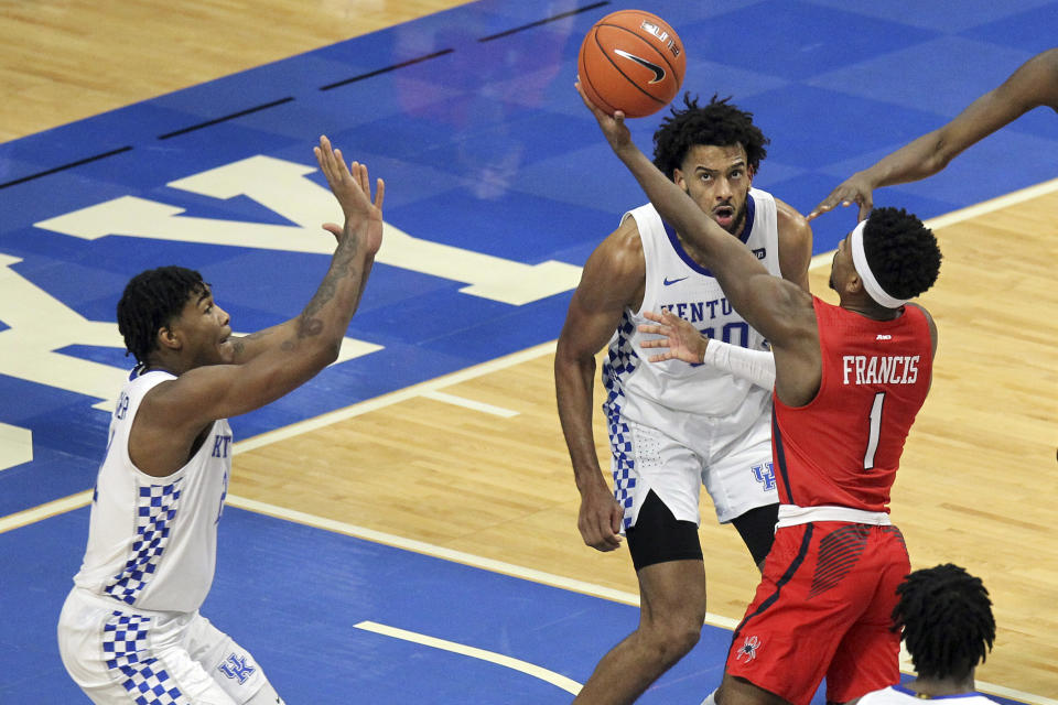 Richmond's Blake Francis (1) shoots near Kentucky's Cam'Ron Fletcher, left, and Olivier Sarr during the second half of an NCAA college basketball game in Lexington, Ky., Sunday, Nov. 29, 2020. (AP Photo/James Crisp)