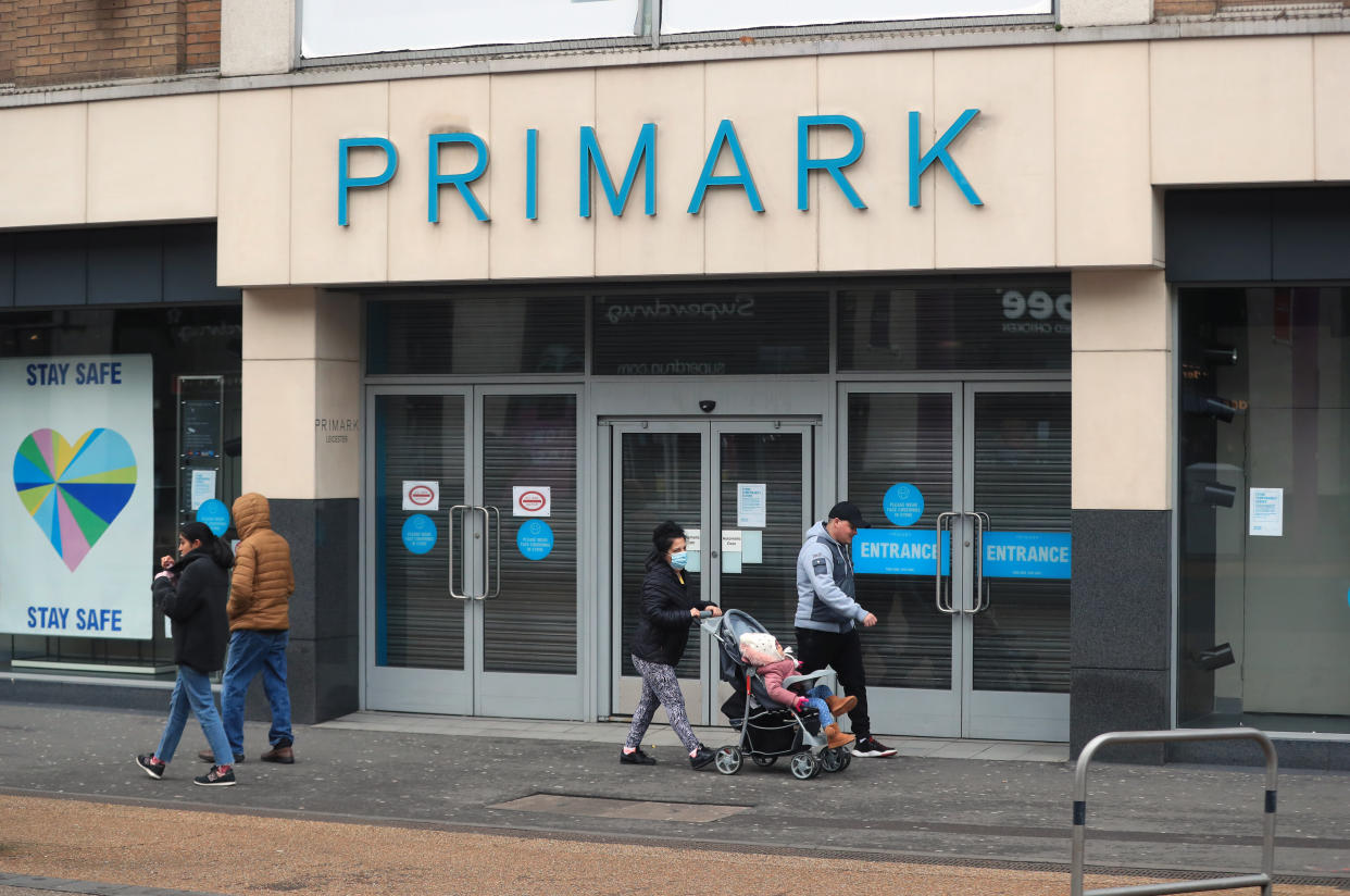 People pass a closed Primark Store in Leicester during England's third national lockdown to curb the spread of coronavirus. (Photo by Mike Egerton/PA Images via Getty Images)