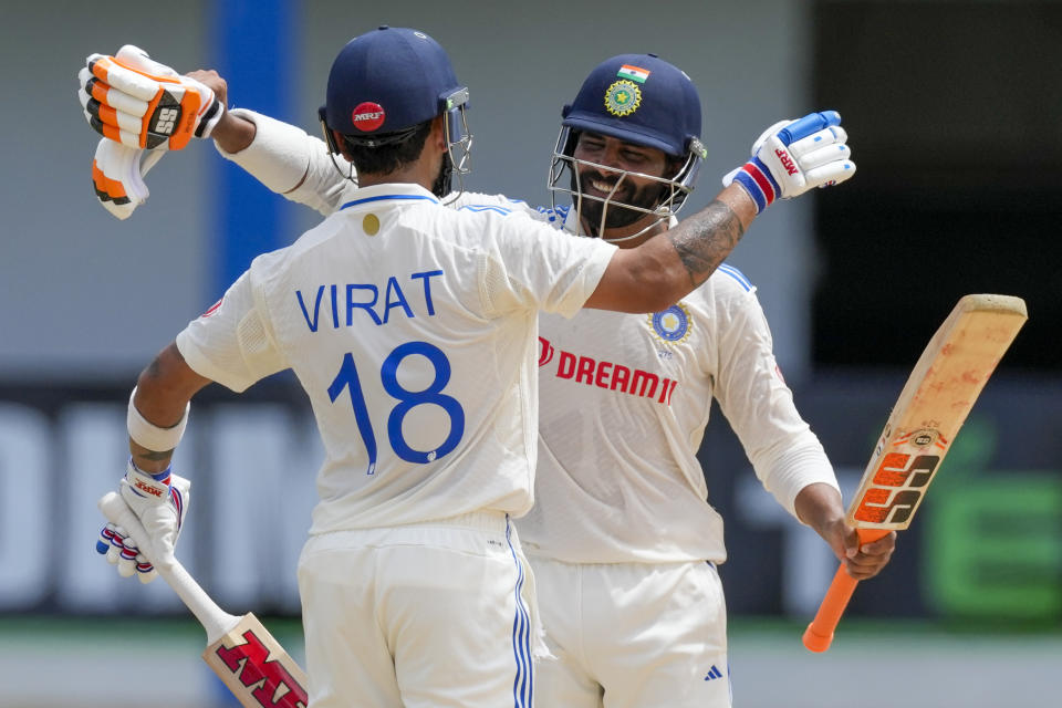 India's Virat Kohli celebrates with teammate India's Ravindra Jadeja after scoring a century against West Indies on day two of their second cricket Test match at Queen's Park in Port of Spain, Trinidad and Tobago, Friday, July 21, 2023. (AP Photo/Ricardo Mazalan)
