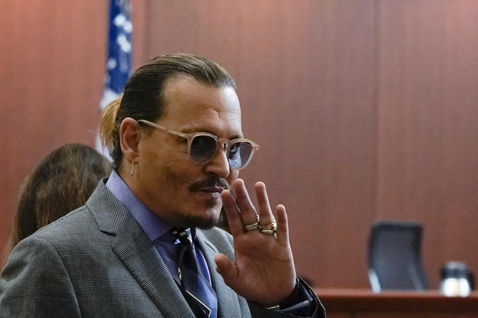 Actor Johnny Depp waves as he arrives in the courtroom at the Fairfax County Circuit Court in Fairfax, Va., Wednesday May 4, 2022. Depp sued his ex-wife Amber Heard for libel in Fairfax County Circuit Court after she wrote an op-ed piece in The Washington Post in 2018 referring to herself as a "public figure representing domestic abuse." (Elizabeth Frantz/Pool Photo via AP)