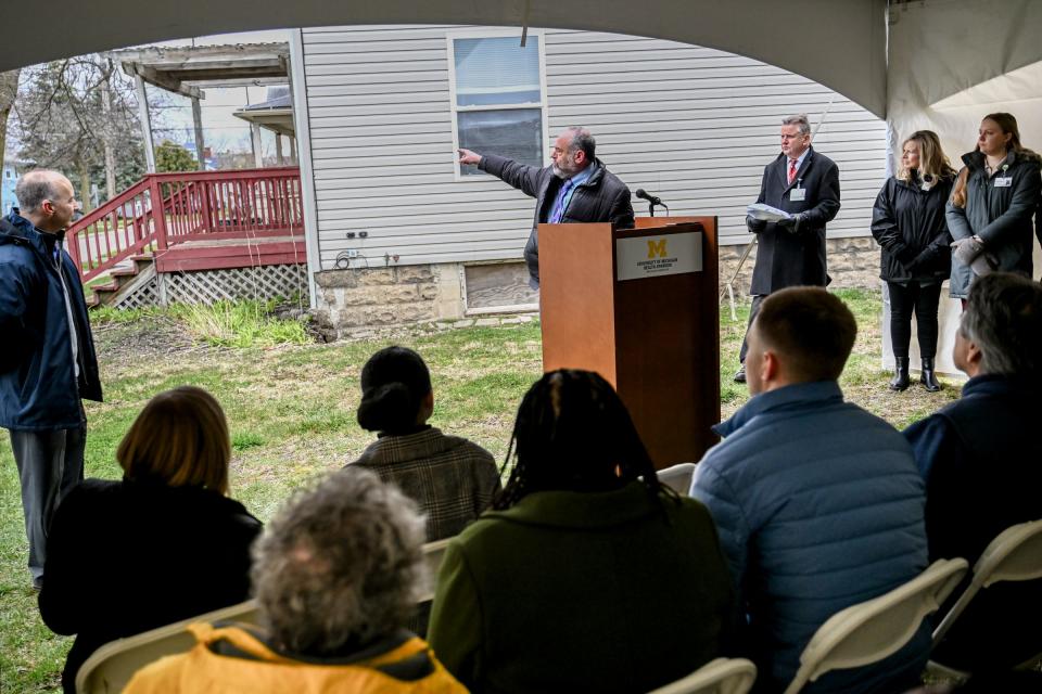 Ingham County Treasurer Alan Fox points to properties to be received by the Ingham County Land Bank during a press conference announcing University of Michigan Health - Sparrow's donation of properties to the county land bank and Habitat for Humanity on Wednesday, April 3, 2024, in Lansing. The plan is to renovate and sell the properties as single family housing.