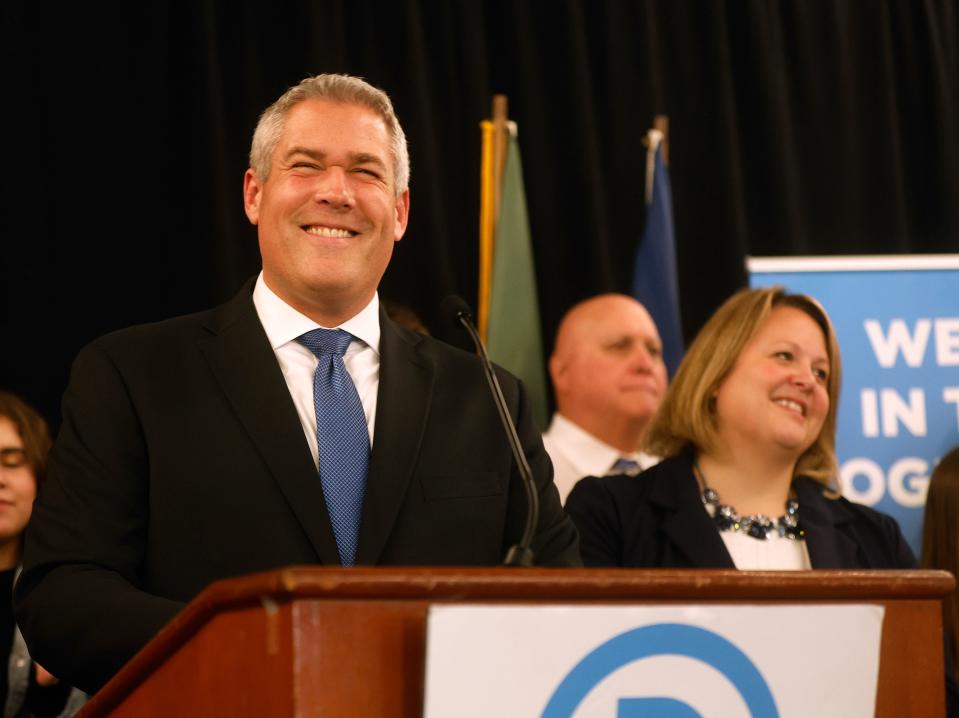 Adam Bello speaks at the Monroe County Democratic Committee party shares a laugh with supporters after being reelected to the office of Monroe County Executive.