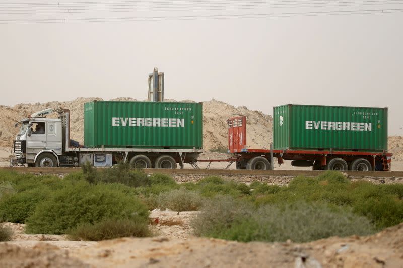 A truck carrying Evergreen containers, waits to pass through the main gate of the El Ain El Sokhna port to Suez Canal