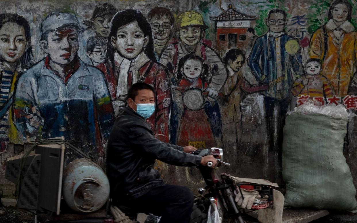 A man wears a face mask amid concerns over coronavirus in Wuhan - STR/AFP via Getty