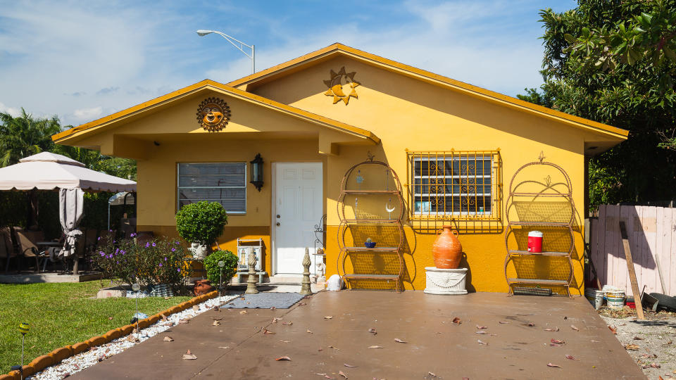 Hialeah, Miami, Florida, USA - November 4, 2012: Yellow House with ornaments in the front and wide driveway.