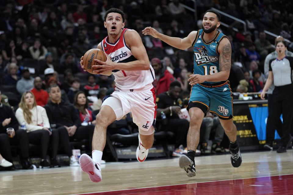 Washington Wizards guard Johnny Davis (1) drives past Detroit Pistons guard Cory Joseph (18) during the first half of an NBA basketball game Tuesday, March 14, 2023, in Washington. (AP Photo/Carolyn Kaster)