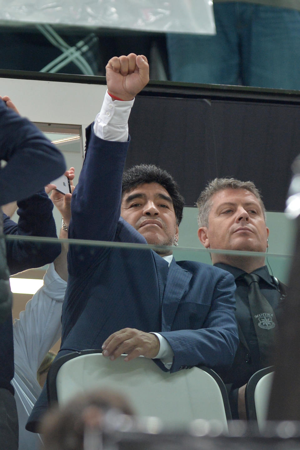 Former Argentinian soccer star Diego Armando Maradona lifts his fist from the stands during the Europa League semifinal second leg soccer match between Juventus and Benfica at the Juventus stadium, in Turin, Italy, Thursday, May 1, 2014. (AP Photo/ Massimo Pinca)