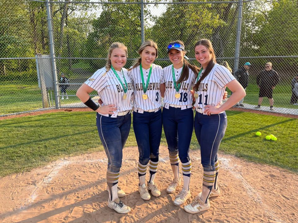 From left, Tallmadge softball teammates Jocelyn Caffelle, Riley Jackson, Sydney Becks and Lexi Gray smile after a 10-0 win over Elyria Catholic in a Division II district championship on May 17, 2023 at Cuyahoga Commuity College West in Parma.