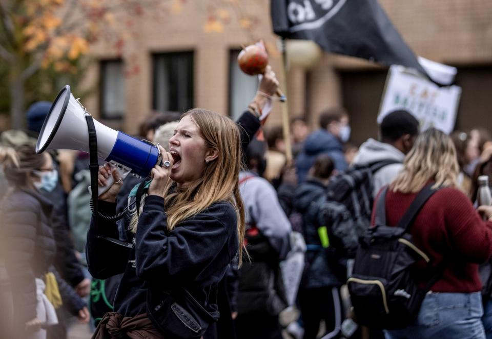 FILE PHOTO: A climate activist shouts slogans into a megaphone during a protest march on the 