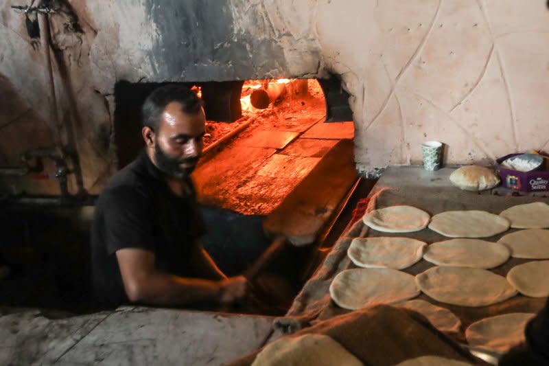 A Palestinian baker prepares bread in a wood-burning stove at a traditional bakery in the Rafah refugee camp in the southern Gaza Strip on Wednesday. Gaza is experiencing a major electricity crisis because of a shortage of fuel. Photo by Ismail Muhammad/UPI