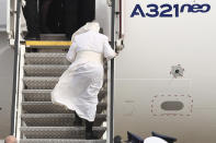 Pope Francis boards in an aircraft departing from Eleftherios Venizelos International Airport in Athens, Greece, Monday, Dec. 6, 2021. Francis' five-day trip to Cyprus and Greece has been dominated by the migrant issue and Francis' call for European countries to stop building walls, stoking fears and shutting out "those in greater need who knock at our door." (AP Photo/Yorgos Karahalis)