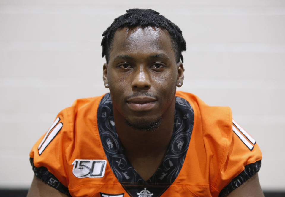 FILE - In this Aug. 3, 2019, file photo, Oklahoma State linebacker Amen Ogbongbemiga poses during an NCAA college football media day in Stillwater Okla. Oklahoma State University officials said Wednesday, June 3, 2020, that three returning student-athletes have tested positive for COVID-19 although they were not showing symptoms. Among them is OSU linebacker Amen Ogbongbemiga, who said on Twitter he tested positive for the virus after he attended a protest in Tulsa. The 21-year-old Ogbongbemiga says he protected himself during the protest. (AP Photo/Sue Ogrocki, File)