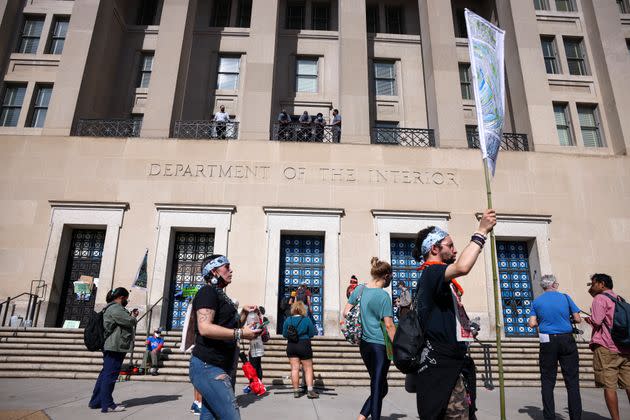 Protesters rally outside the Department of Interior as climate activists hold a sit-in inside the agency's headquarters on Oct. 14. (Photo: Kevin Dietsch via Getty Images)