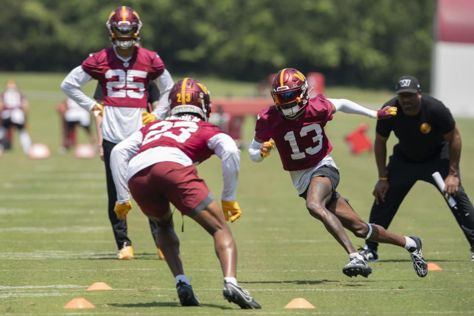 Washington Commanders Emmanuel Forbes Jr.,(13) and Chigozie Anusiem (23) run a play during NFL football practice in Ashburn, Va., Wednesday, May 22, 2024. (AP Photo/Jose Luis Magana)